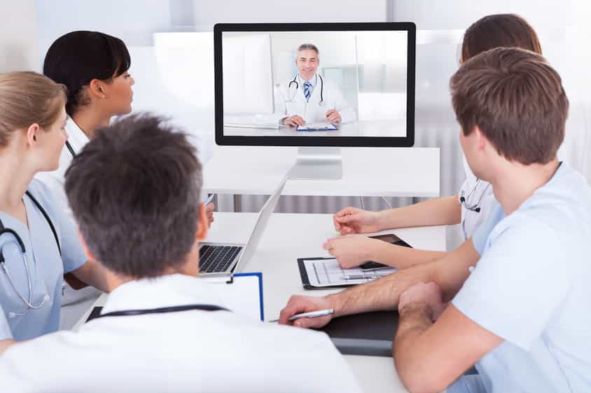 Healthcare professionals collaborating with an RPM system