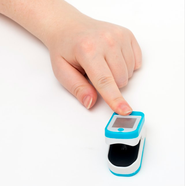 A person touching a remote patient monitoring device