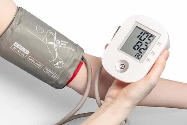 A person touching a remote patient monitoring device